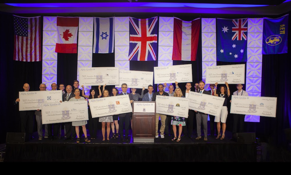 AEPi's ten beneficiaries gather on stage to be recognized at the Official Philanthropy Lunch and receive their donation check.
