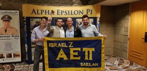 Vav/Israel Zeta Brothers take a photo with their chapter flag and gavel after being announced as a fall 2018 colony that would receive its charter.